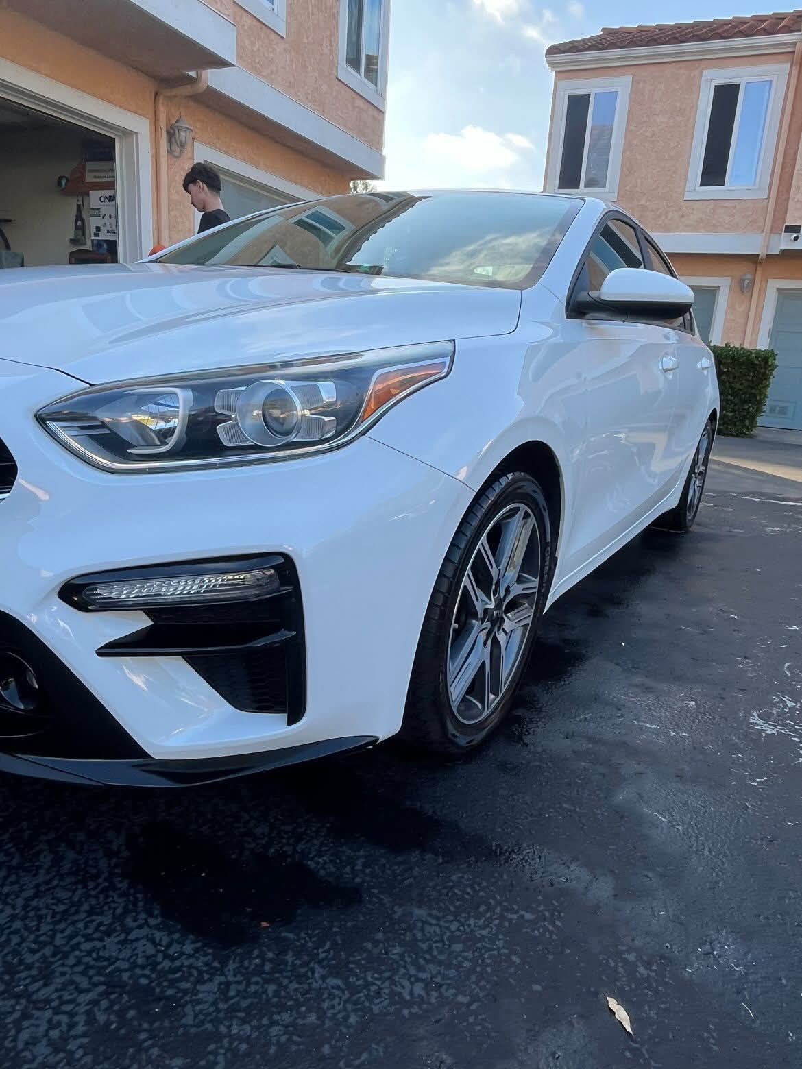 Freshly detailed white car in Oceanside, glossy exterior finish